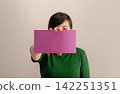 Woman holding a blank square card, communication, identity, messaging 142251351