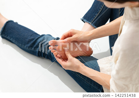 Woman touching the foot Woman touching the foot 142251438