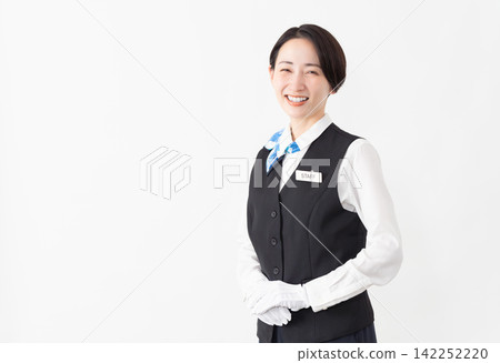 A female attendant in uniform; travel image 142252220