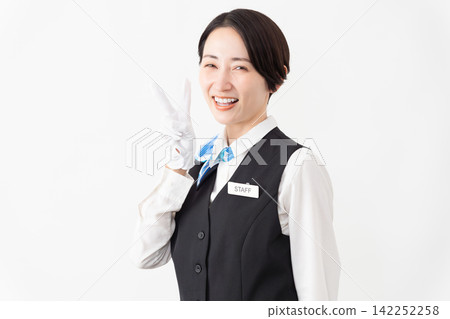 A female attendant in uniform; travel image 142252258