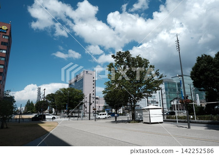 The station square and high-rise buildings in the daytime with a blue sky and white clouds. The station square and high-rise buildings in the daytime with a blue sky and white clouds. 142252586