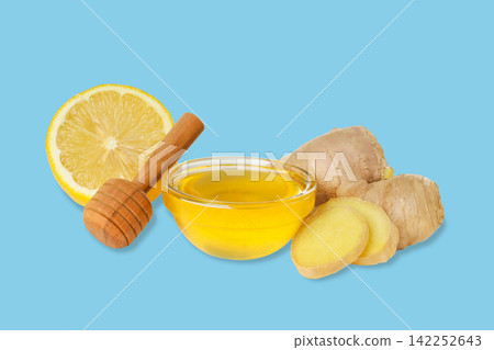 Ginger root, honey, and lemon are arranged beautifully on a vibrant backdrop Ginger root, honey, and lemon are arranged beautifully on a vibrant backdrop 142252643