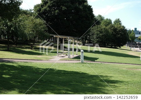 The park features a gazebo, a grassy area, and an outdoor resting space surrounded by trees. The park features a gazebo, a grassy area, and an outdoor resting space surrounded by trees. 142252659