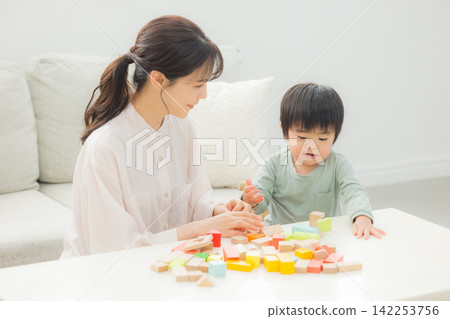 Parents playing with building blocks Parents playing with building blocks 142253756