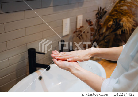 A housewife's hands washing them thoroughly A housewife's hands washing them thoroughly 142254422