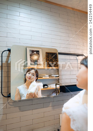 A young woman enjoying beauty and showing a smile. A young woman enjoying beauty and showing a smile. 142254449