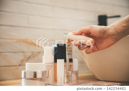 Hands of a woman doing skin care with cream Hands of a woman doing skin care with cream 142254481