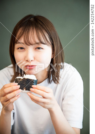 A young woman eating indoors A young woman eating indoors 142254782