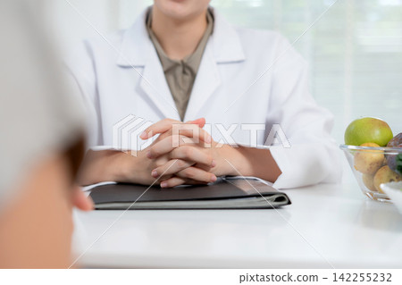 Asian woman nutritionist doctor discussing medical treatment with senior patient. Asian woman nutritionist doctor discussing medical treatment with senior patient. 142255232
