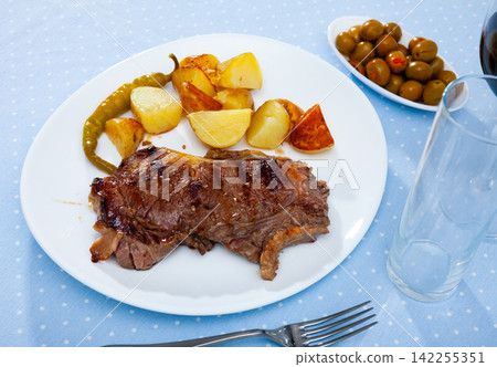 Grilled beef steak with potatoes and jalapenos peppers 142255351