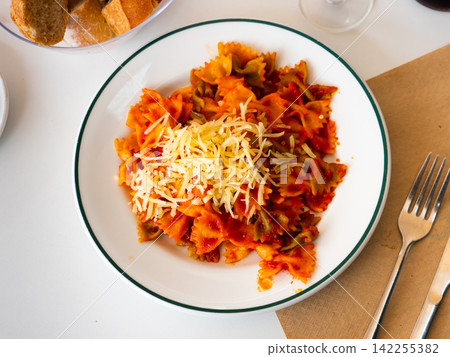 Portion of farfalle pasta with tomato sauce Portion of farfalle pasta with tomato sauce 142255382
