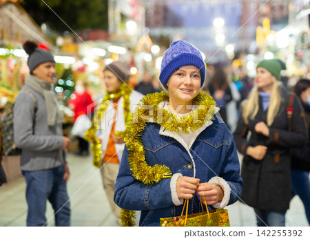 Portrait of a fourteen-year-old teenage girl at the Christmas fair Portrait of a fourteen-year-old teenage girl at the Christmas fair 142255392