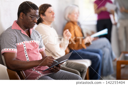 African man in line for interview at reception African man in line for interview at reception 142255404
