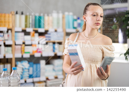Pregnant woman are busy choosing emollient cream at pharmacy Pregnant woman are busy choosing emollient cream at pharmacy 142255490