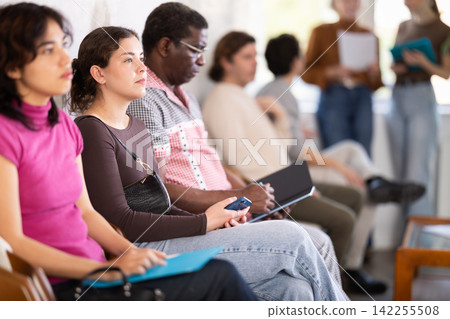 Young woman applicant sitting in a queue at a modern office Young woman applicant sitting in a queue at a modern office 142255508