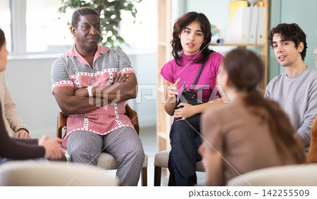 Diverse group of people sitting in a circle and chatting Diverse group of people sitting in a circle and chatting 142255509