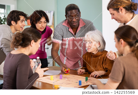 Group of different ages playing board game at table Group of different ages playing board game at table 142255569
