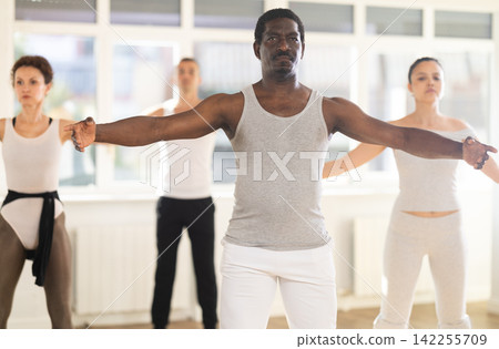 Group of men and women stand in second position Group of men and women stand in second position 142255709