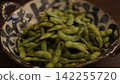 Salt-boiled edamame from Yamagata Prefecture, served in a bowl as a summer snack. 142255720