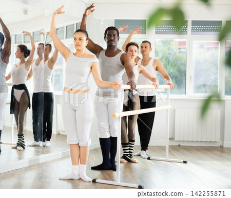 Group of men and women will learn to stand in third position during ballet rehearsal Group of men and women will learn to stand in third position during ballet rehearsal 142255871