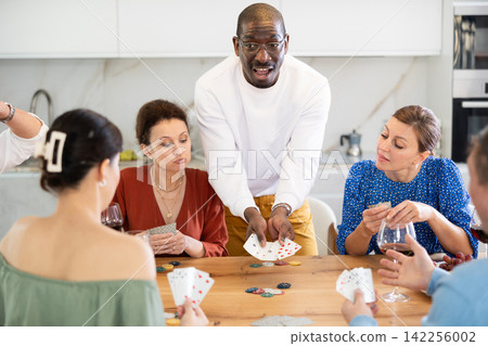 Excited African American winning in friendly poker game at home Excited African American winning in friendly poker game at home 142256002