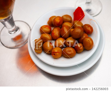 White plate with delicious pitted olives White plate with delicious pitted olives 142256003
