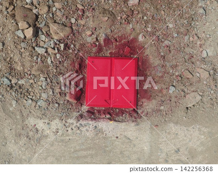 Red boundary markers (with arrows) embedded in the ground. Red boundary markers (with arrows) embedded in the ground. 142256368
