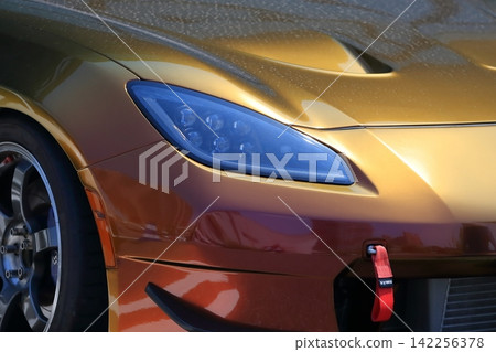 Gold Japanese sports car Gold Japanese sports car 142256378