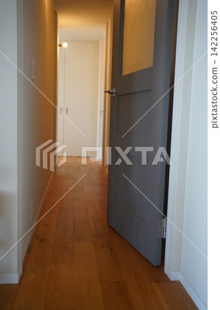 Close-up of a high door / Residential interior, wooden wall, stylish interior door Close-up of a high door / Residential interior, wooden wall, stylish interior door 142256405