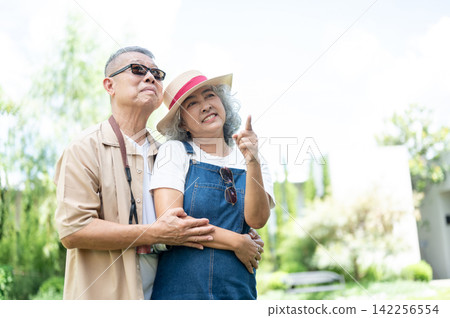 Asian senior Mature Couple Enjoying Coffee and Travel at a Cafe Asian senior Mature Couple Enjoying Coffee and Travel at a Cafe 142256554