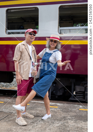 Asian Senior Mature Couple Traveling by Train on Vacation Asian Senior Mature Couple Traveling by Train on Vacation 142256560