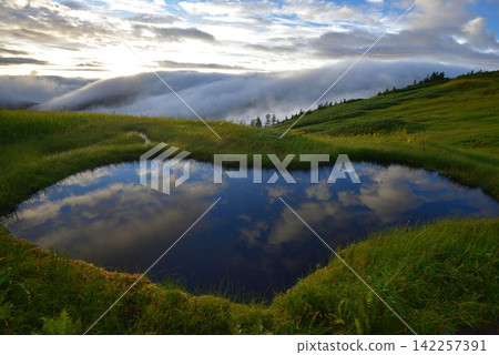 A pond reflecting the early morning blue sky, on the ridge from Mount Aizu-Komagatake to Mount Nakamondake. A pond reflecting the early morning blue sky, on the ridge from Mount Aizu-Komagatake to Mount Nakamondake. 142257391