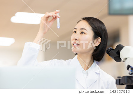 Research Image: A woman working in a research lab. Photography cooperation: Denpa Gakuen Tokyo Electronics College. Research Image: A woman working in a research lab. Photography cooperation: Denpa Gakuen Tokyo Electronics College. 142257913