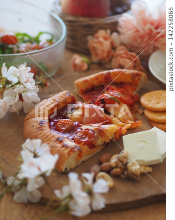 A table to enjoy pizza, cheese, and nuts. A table to enjoy pizza, cheese, and nuts. 142258066