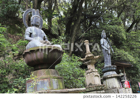 The statues of the Bodhisattva of Safe Childbirth and Kannon Bodhisattva are located within the tranquil grounds of Gokuraku-ji Temple, the second temple on the Shikoku 88 Temple Pilgrimage. The statues of the Bodhisattva of Safe Childbirth and Kannon Bodhisattva are located within the tranquil grounds of Gokuraku-ji Temple, the second temple on the Shikoku 88 Temple Pilgrimage. 142258226