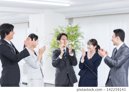 A business group applauding. Teamwork, celebration, congratulations, company, success, achievement, work, accomplishment, goal, challenge A business group applauding. Teamwork, celebration, congratulations, company, success, achievement, work, accomplishment, goal, challenge 142259141