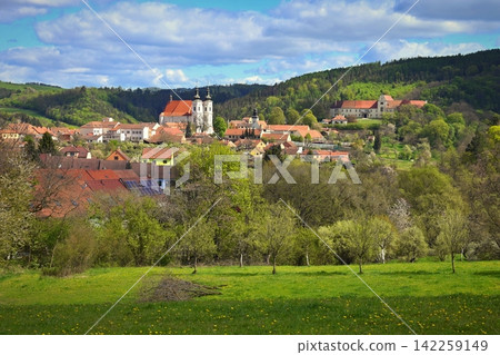 Panoramic view of Lomnice town with Church of the Visitation of the Virgin Mary and castle surrounded by green hills, Czech Republic. Panoramic view of Lomnice town with Church of the Visitation of the Virgin Mary and castle surrounded by green hills, Czech Republic. 142259149