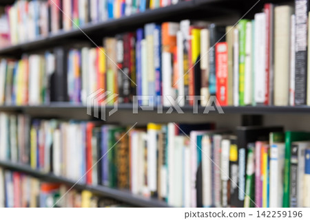 Bookshelves filled with books. Blurred image for illustrative purposes. Bookstore, library, publishing, novels, paperbacks, comics, manga, reading Bookshelves filled with books. Blurred image for illustrative purposes. Bookstore, library, publishing, novels, paperbacks, comics, manga, reading 142259196