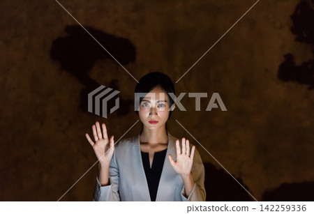 A woman operating a screen in mid-air in the dark. VR, virtual, sci-fi, touch, HUD, UX, tech, hologram A woman operating a screen in mid-air in the dark. VR, virtual, sci-fi, touch, HUD, UX, tech, hologram 142259336
