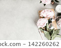 Feminine Flat Lay with Peonies, Notebook, and Eyeglasses 142260262