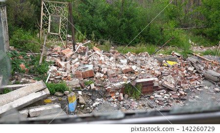 View to destroyed residential buildings at Kharkivska oblast. Ruined houses after bomb attacks on ukrainian territory from russia army. Consequences of russian invasion of Ukraine. Slow motion View to destroyed residential buildings at Kharkivska oblast. Ruined houses after bomb attacks on ukrainian territory from russia army. Consequences of russian invasion of Ukraine. Slow motion 142260729
