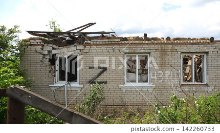 View to destroyed residential buildings at Kharkivska oblast. Ruined houses after bomb attacks on ukrainian territory from russia army. Consequences of russian invasion of Ukraine. Slow motion View to destroyed residential buildings at Kharkivska oblast. Ruined houses after bomb attacks on ukrainian territory from russia army. Consequences of russian invasion of Ukraine. Slow motion 142260733