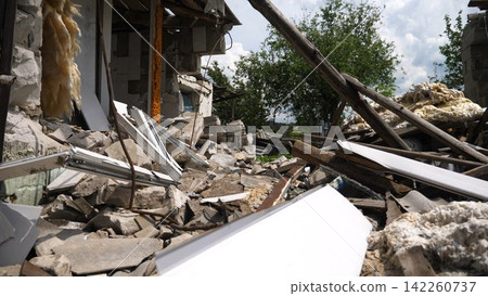 View to destroyed residential buildings at Kharkivska oblast. Ruined houses after bomb attacks on ukrainian territory from russia army. Consequences of russian invasion of Ukraine. Slow motion View to destroyed residential buildings at Kharkivska oblast. Ruined houses after bomb attacks on ukrainian territory from russia army. Consequences of russian invasion of Ukraine. Slow motion 142260737
