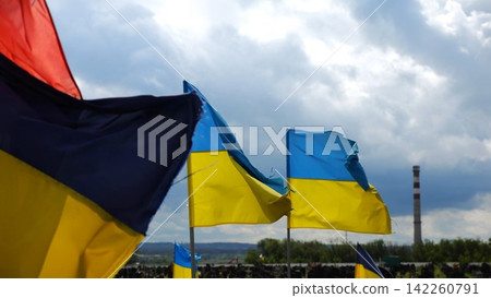 View on blue-yellow flags at countless graves of ukrainian soldiers alley of glory in Kharkiv. This site commemorates heroes and maintains the memory of wartime events in Ukraine. Slow moiton View on blue-yellow flags at countless graves of ukrainian soldiers alley of glory in Kharkiv. This site commemorates heroes and maintains the memory of wartime events in Ukraine. Slow moiton 142260791
