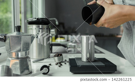 powder coffee with hand people pouring Roasted coffee for espresso coffee into the cup with equipment tool brewing Italian Moka pot, coffee at kitchen home. preparation drink powder coffee with hand people pouring Roasted coffee for espresso coffee into the cup with equipment tool brewing Italian Moka pot, coffee at kitchen home. preparation drink 142261225