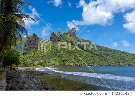 Hatiheu Bay and Beach, Nuku Hiva, French Polynesia, with lush cliffs Hatiheu Bay and Beach, Nuku Hiva, French Polynesia, with lush cliffs 142261424