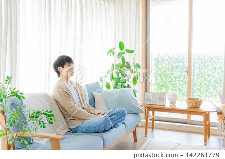 A man relaxing in the living room A man relaxing in the living room 142261779