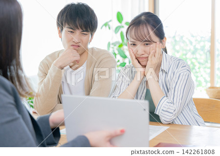 A couple consults a financial planner A couple consults a financial planner 142261808