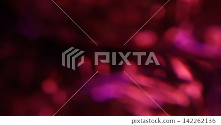 Bokeh light. Pink glitter texture. Vibrant purple color lens flare bright optical glisten reflection on abstract illuminated black background. 142262136