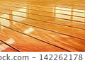 Wooden floor with reflection in the water. Selective focus. 142262178